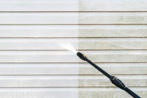 Cleaning service washing building facade with pressure washer in Albuquerque